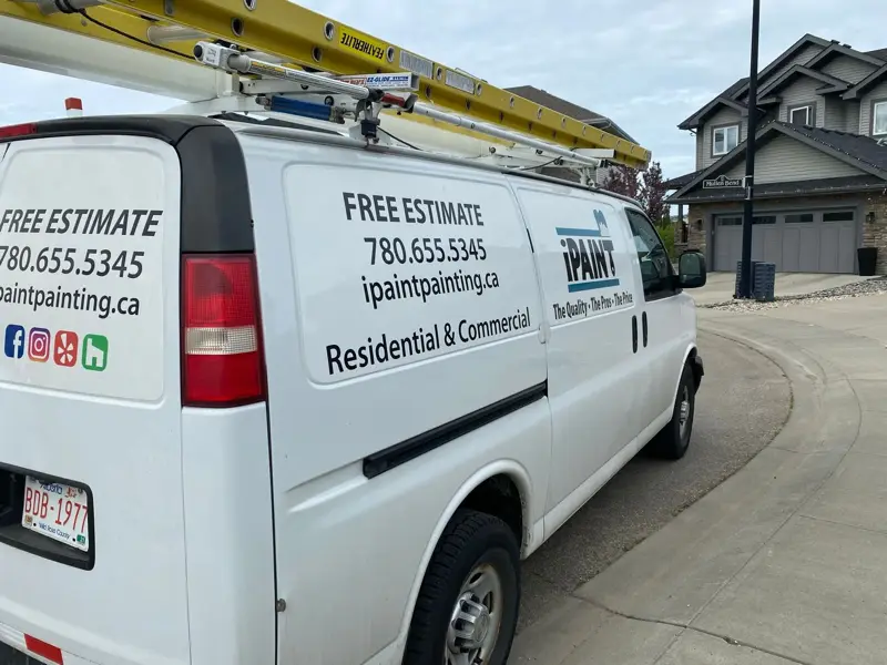 iPaint Painting branded work van with ladder rack in an Edmonton neighbourhood